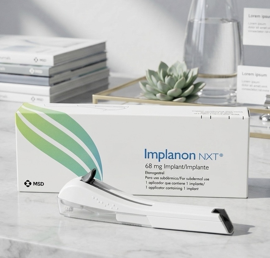 Implanon NXT 68 mg etonogestrel implant box and single-rod applicator on a clean marble clinic table in natural light